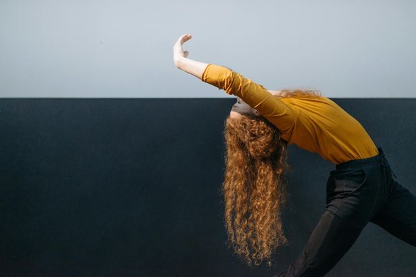 Person performing a gentle back stretch, promoting flexibility.