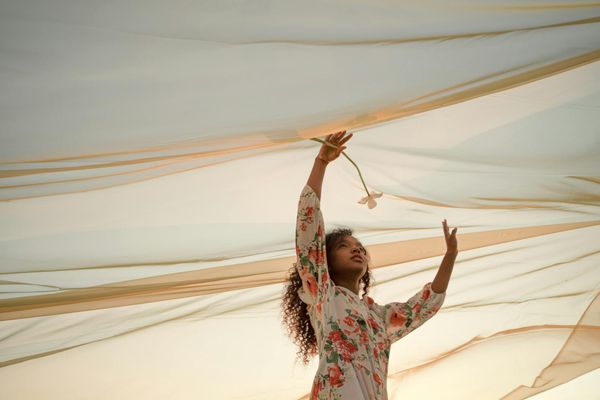 Woman gracefully flowing through a gentle yoga sequence.
